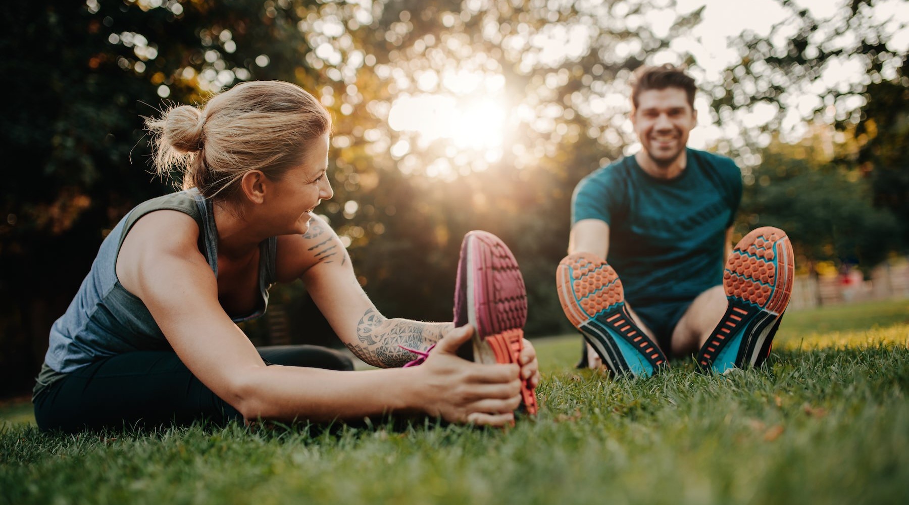 TOWNHOME RENTALS AT WALDORF woman and man stretching in the grass